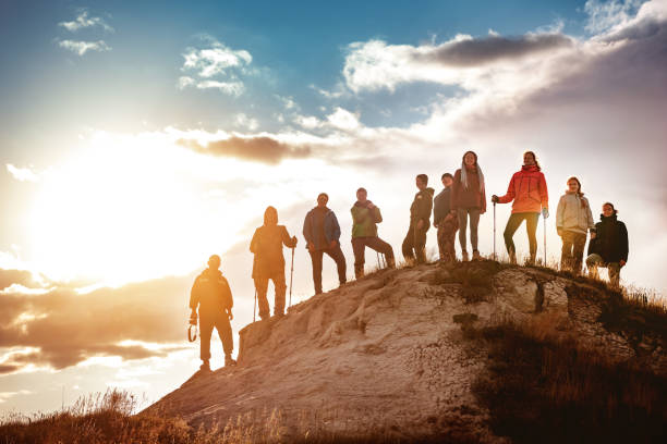 istock Big group of hikers against sunset 1189926029