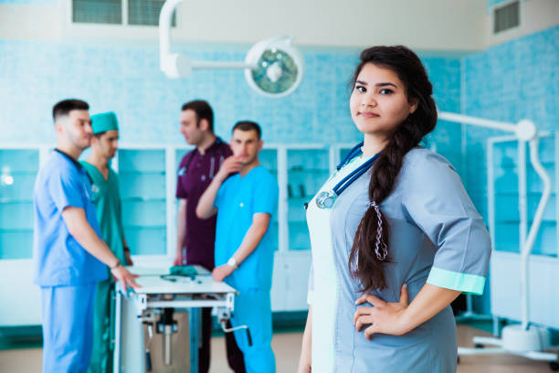 portrait of a successful professional doctor. the staff of the medical faculty. multinational people - doctor, nurse and surgeon. a group of graduates of a medical university in a surgical room. - medical student healthcare and medicine book education imagens e fotografias de stock