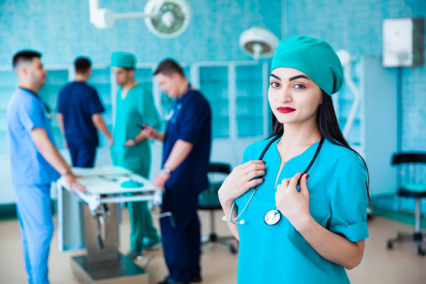 portrait of a successful professional doctor. the staff of the medical faculty. multinational people - doctor, nurse and surgeon. a group of graduates of a medical university in a surgical room. - medical student healthcare and medicine book education imagens e fotografias de stock