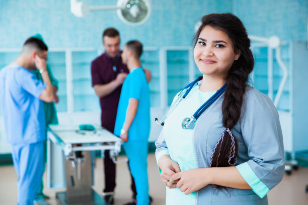 portrait of a successful professional doctor. the staff of the medical faculty. multinational people - doctor, nurse and surgeon. a group of graduates of a medical university in a surgical room. - medical student healthcare and medicine book education imagens e fotografias de stock