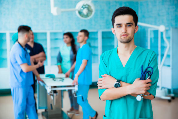 portrait of a successful professional doctor. the staff of the medical faculty. multinational people - doctor, nurse and surgeon. a group of graduates of a medical university in a surgical room. - medical student healthcare and medicine book education imagens e fotografias de stock