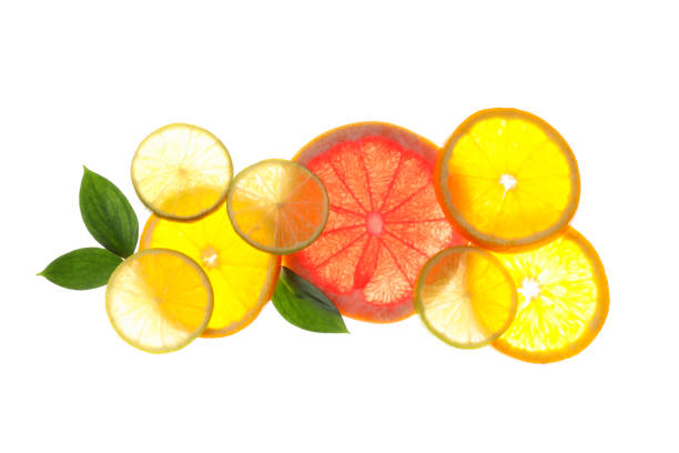 istock Backlit slices of grapefruit and lemon isolated on white background 1189927723