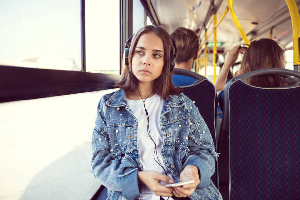 ragazza premurosa che ascolta musica in autobus - transportation bus mode of transport public transportation foto e immagini stock