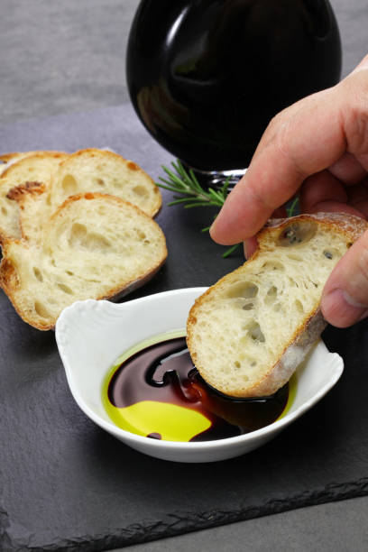 istock dipping baguette into balsamic vinegar and olive oil sauce 1189928971