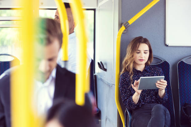 istock Businesswoman using digital tablet in bus 1189928989