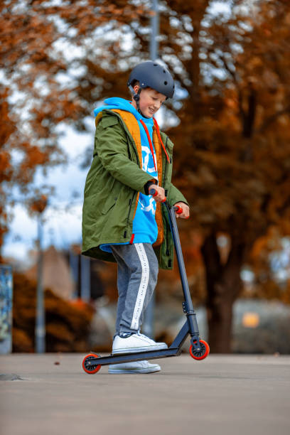 istock Boy jumping with his scooter 1189929445