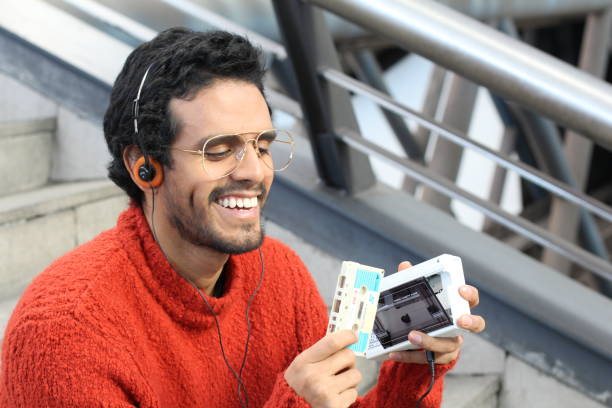 Ethnic guy using a walkman Ethnic guy using a walkman. audio cassette photos stock pictures, royalty-free photos & images