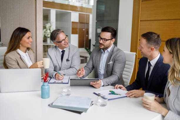 istock Group of business people having meeting around tablet computer 1189930944