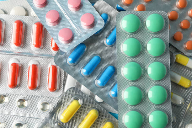 istock Pills in blister packs textured background, close up 1189931769