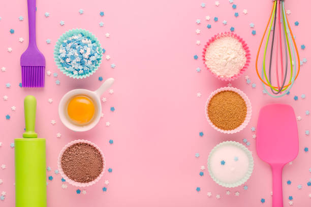 istock baking ingredients, egg, flour, cocoa, sugar, sweet decoration and kitchen tools on pink background 1189932223