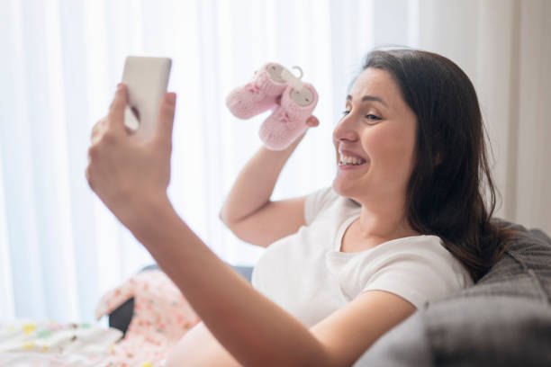 istock Baby clothes, taking photo 1189932650