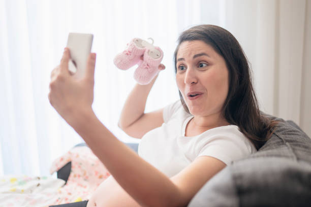 istock Baby clothes, taking photo 1189932664