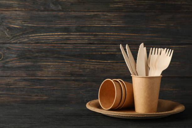 istock Eco - friendly tableware on wooden background, space for text 1189933911