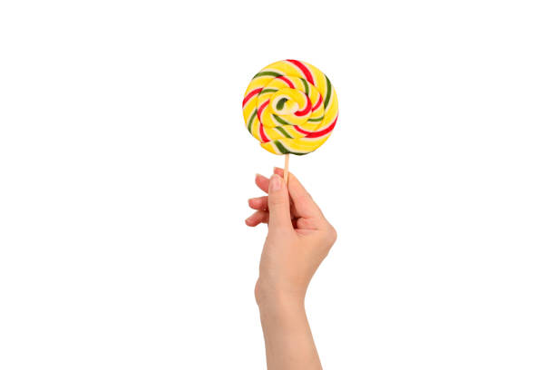 istock Lollipop in female hand isolated on white  background. Space for text or design. 1189935561