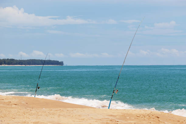 istock Fishing rods on the sandy beach 1189936857