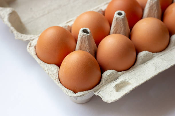 istock Stack of many brown and speckled fresh raw chicken eggs in the cardboard tray box packaging for sale in supermarket 1189937487
