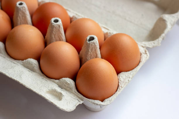 istock Stack of many brown and speckled fresh raw chicken eggs in the cardboard tray box packaging for sale in supermarket 1189937506