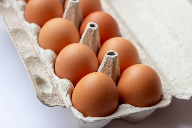 istock Stack of many brown and speckled fresh raw chicken eggs in the cardboard tray box packaging for sale in supermarket 1189937603