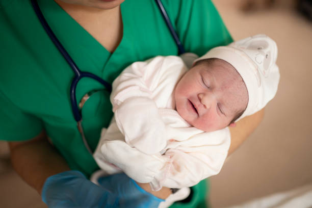 New born baby and doctor New born baby and doctor maternity ward stock pictures, royalty-free photos & images