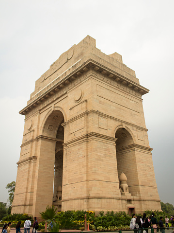 Delhi, India - September 30, 2019 : The India Gate, a war memorial standing on the Rajpath of New Delhi, with visitors around it.