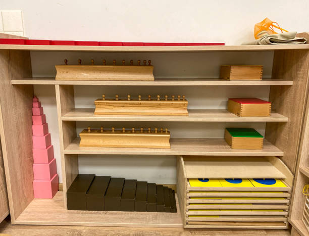 sensory police with montessori materials red bars, cylinder blocks, color cylinders, pink tower, brown staircase and geometric chest of drawers sensory police with montessori materials red bars, cylinder blocks, color cylinders, pink tower, brown staircase and geometric chest of drawers montessori education photos stock pictures, royalty-free photos & images