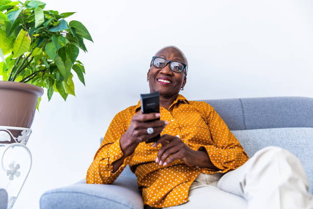 istock Senior Woman Watching Tv 1189942932