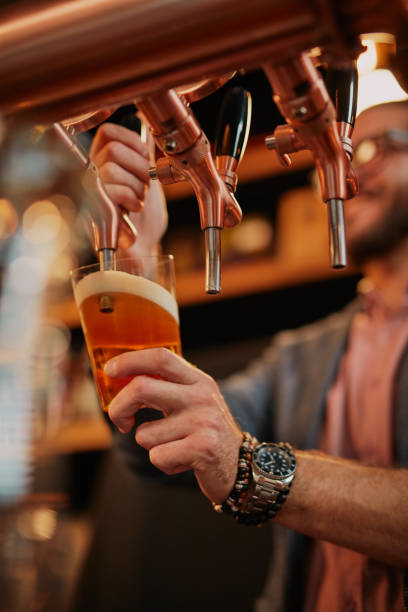 istock Barman pouring beer. 1189944086