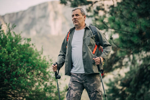 istock Hiking an older man on a mountain for recreation 1189945592