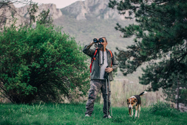 istock Hiking an older man on a mountain for recreation with a dog 1189945714