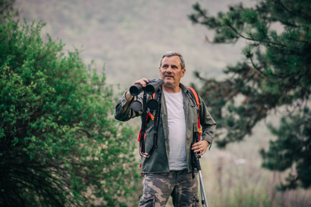 istock Hiking an older man on the mountain for binoculars recreation 1189945716