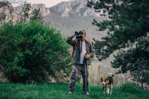 istock Hiking an older man on a mountain for recreation with a dog 1189945757