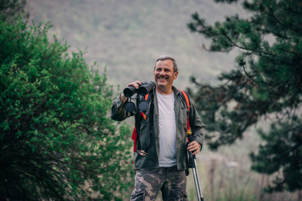 istock Hiking an older man on the mountain for binoculars recreation 1189945793