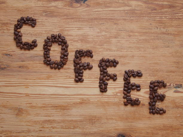 istock Coffee beans which are lined with the inscription Coffee. 1189946094