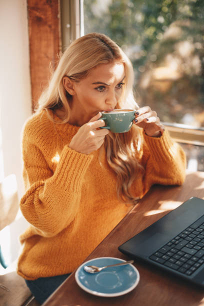 istock Concentrated blonde female copywriter working on creative task at the cafe. 1189947522