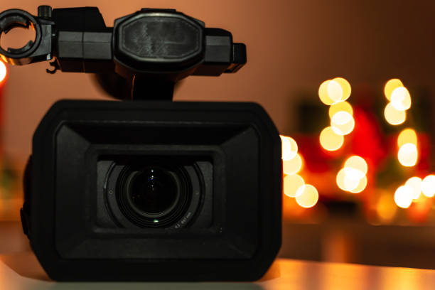 istock Home video camera lens, Christmas lights in background, bokeh 1189947540
