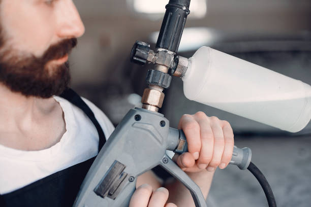 istock Man washing his car in a garage 1189948931