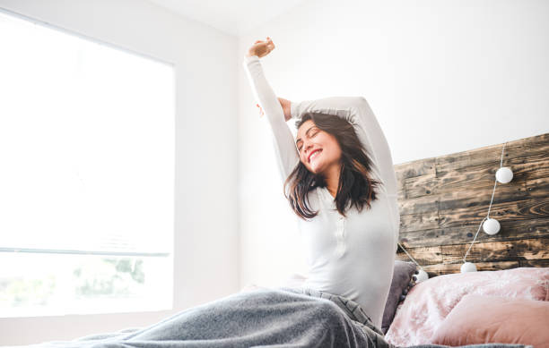 i feel well rested - stretching women attractive female indoors imagens e fotografias de stock