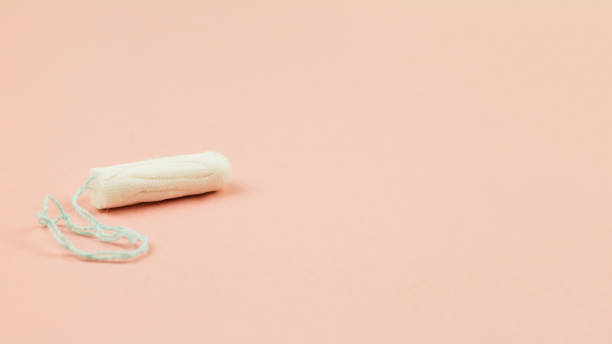 istock Menstruation cotton tampon on pink background with copy space 1189950428
