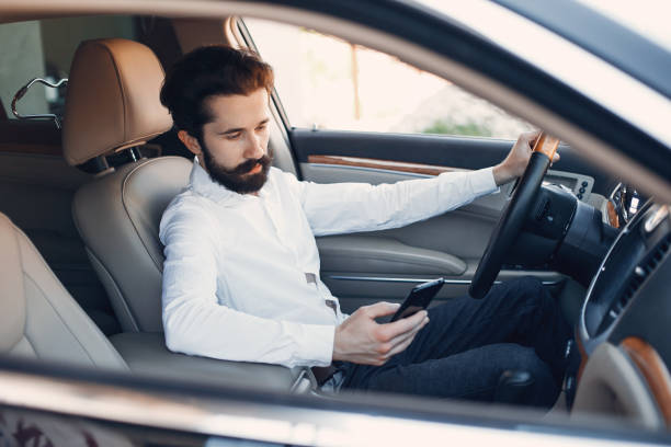 istock Handsome and elegant man in a car salon 1189951767