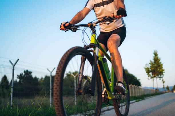 istock Cyclist is on the sunset road 1189952385