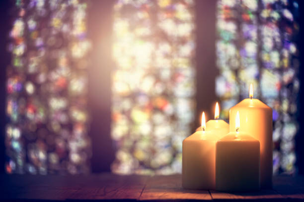 Candles in a church background Candles burning in a church background stained glass photos stock pictures, royalty-free photos & images
