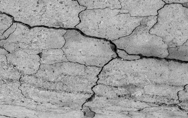istock Abstract cement background. Cracked concrete texture closeup. 1189956760