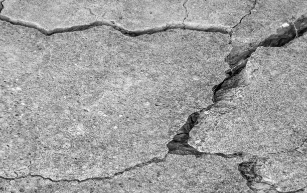 istock Abstract cement background. Cracked concrete texture closeup. 1189956901