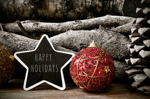 a star-shaped chalkboard with the text happy holidays surrounded by christmas balls and natural ornaments such as pine cones