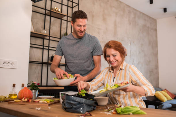 istock Man helping his wife to  separate organic garbage for composting 1189959911