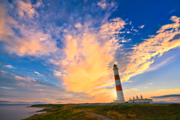 istock lighthouse golden sunset - Scotland 1189961938