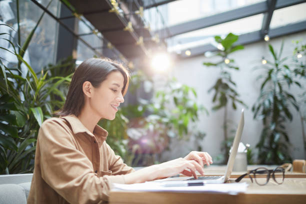 istock Female Entrepreneur Using Laptop in Outdoor Cafe 1189962585