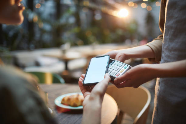 istock Woman Paying via Smartphone in Cafe 1189962904