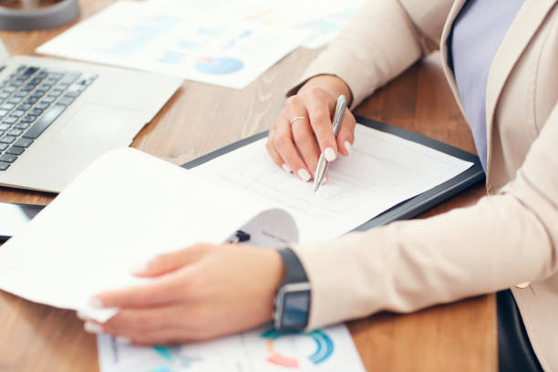 istock Businesswoman doing Paperwork Closeup 1189964519