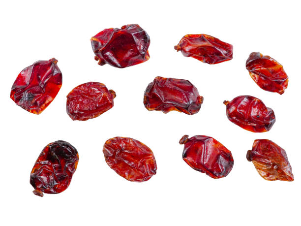Some dried cranberries isolated on white background with copy space for text or images. Food, cooking, packaging concept. Close-up stock photo
